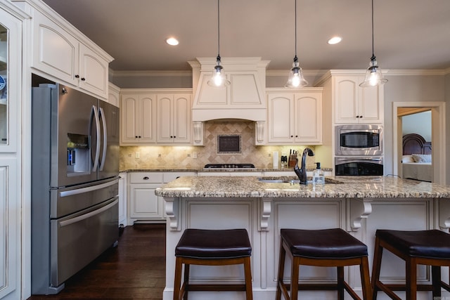 6 W Lake Ln, Little Rock, AR 72210 - kitchen with stainless steel appliances, a sink, light stone counters, crown molding, and dark wood-style flooring