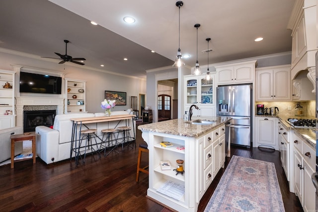6 W Lake Ln, Little Rock, AR 72210 - kitchen featuring crown molding, open shelves, appliances with stainless steel finishes, a sink, and open floor plan