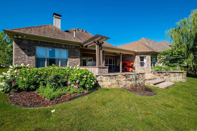 6 W Lake Ln, Little Rock, AR 72210 - back of property featuring brick siding, a lawn, a ceiling fan, a patio, and roof with shingles