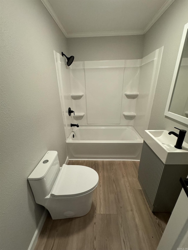 full bath with wood finished floors, toilet, vanity, tub / shower combination, and crown molding