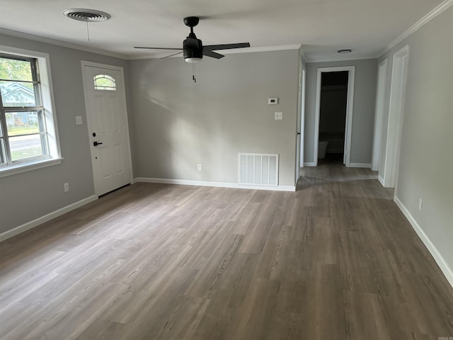 unfurnished living room featuring crown molding, wood finished floors, ceiling fan, and baseboards