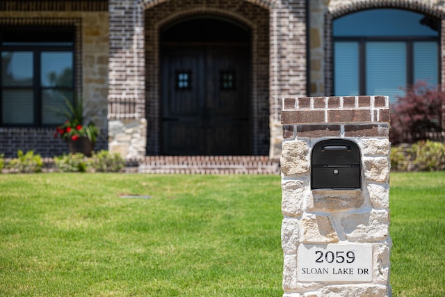 2059 Sloan Lake Dr, Jonesboro, AR 72404 - doorway to property with brick siding and a yard