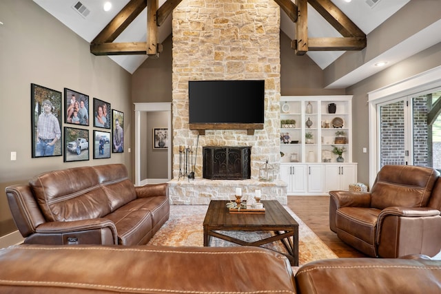 2059 Sloan Lake Dr, Jonesboro, AR 72404 - living area with high vaulted ceiling, a stone fireplace, wood finished floors, beam ceiling, and baseboards