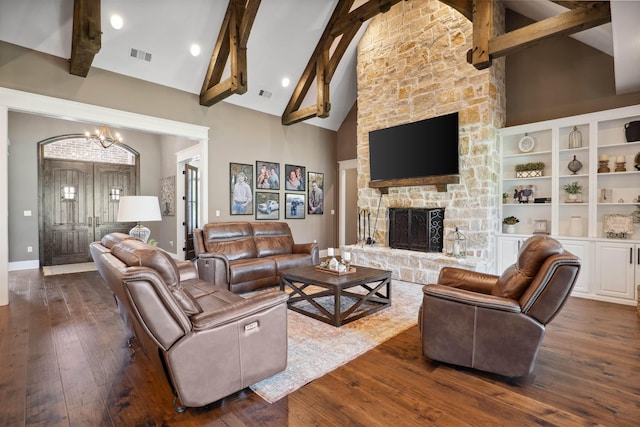 2059 Sloan Lake Dr, Jonesboro, AR 72404 - living area featuring a chandelier, high vaulted ceiling, beam ceiling, dark wood-style flooring, and a stone fireplace