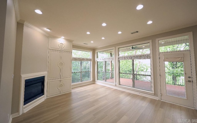 10 Calumet Rd, Little Rock, AR 72223 - unfurnished living room featuring crown molding, light wood-style floors, recessed lighting, and a glass covered fireplace