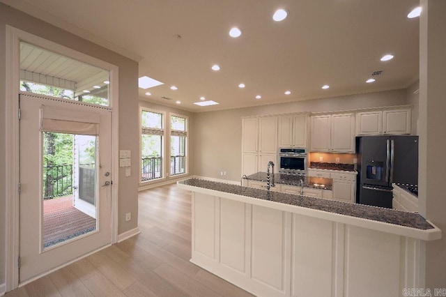 10 Calumet Rd, Little Rock, AR 72223 - kitchen with black refrigerator with ice dispenser, light wood finished floors, white cabinets, recessed lighting, and ornamental molding