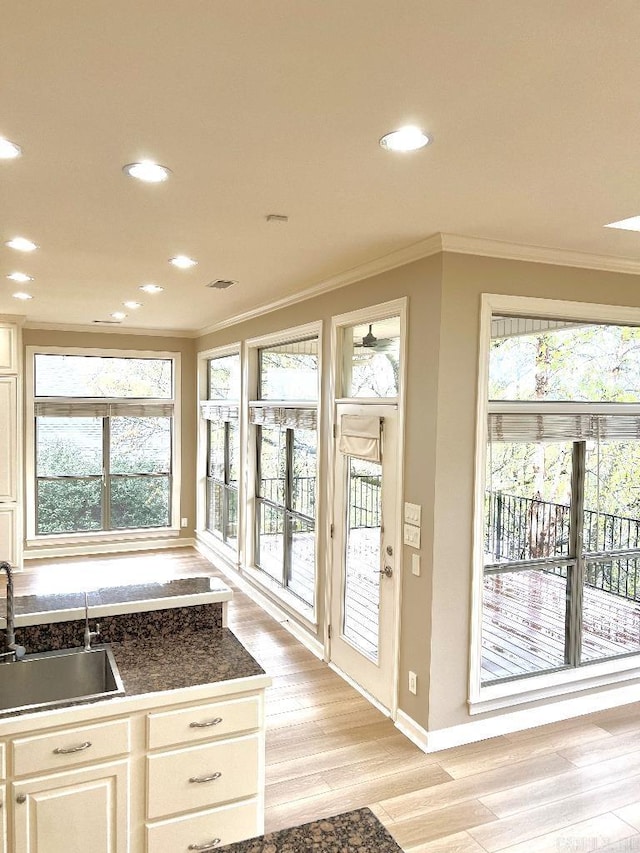 10 Calumet Rd, Little Rock, AR 72223 - doorway to outside featuring a sink, crown molding, light wood-type flooring, recessed lighting, and baseboards