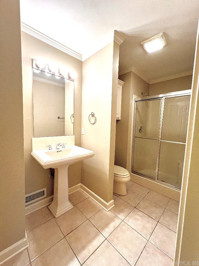 10 Calumet Rd, Little Rock, AR 72223 - bathroom featuring crown molding, tile patterned floors, toilet, a stall shower, and baseboards