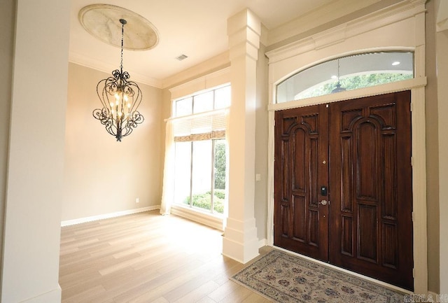 10 Calumet Rd, Little Rock, AR 72223 - entrance foyer with wood finished floors, a chandelier, healthy amount of natural light, baseboards, and crown molding