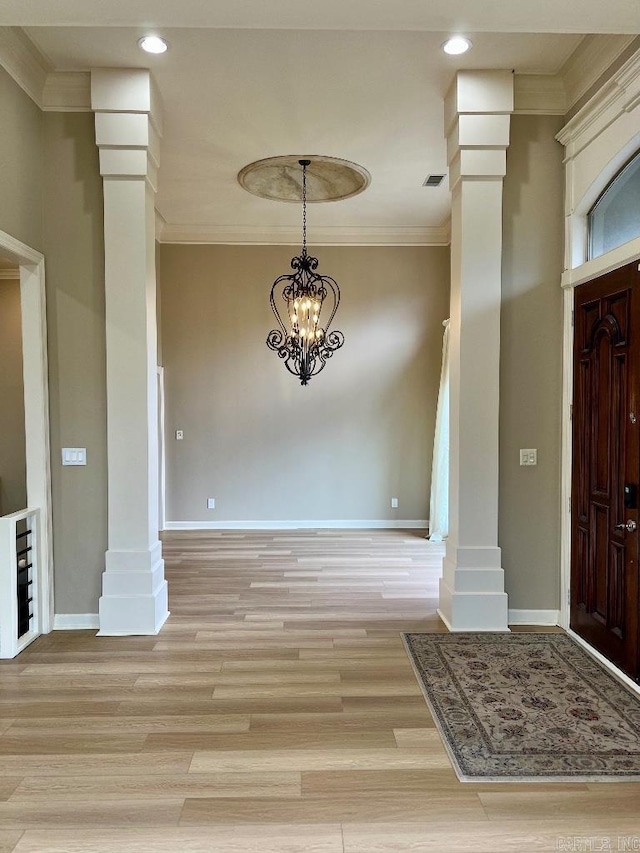 10 Calumet Rd, Little Rock, AR 72223 - foyer entrance featuring crown molding, baseboards, light wood-type flooring, ornate columns, and a chandelier