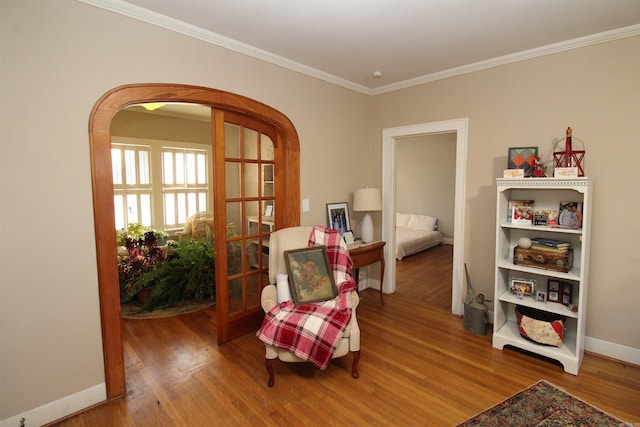 605 School St, Sheridan, AR 72150 - sitting room with arched walkways, wood finished floors, ornamental molding, and baseboards