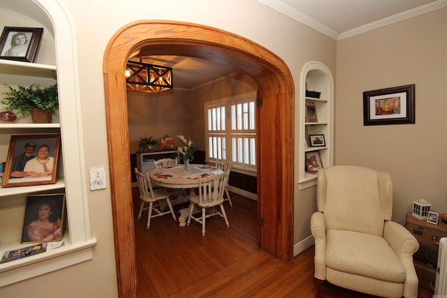 605 School St, Sheridan, AR 72150 - dining area with wood finished floors, crown molding, arched walkways, built in features, and baseboards