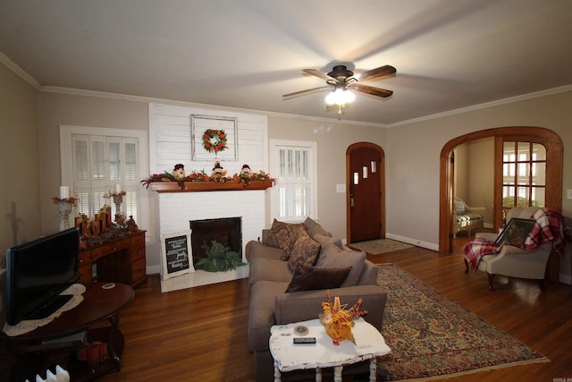 605 School St, Sheridan, AR 72150 - living room featuring arched walkways, wood finished floors, a ceiling fan, crown molding, and a brick fireplace