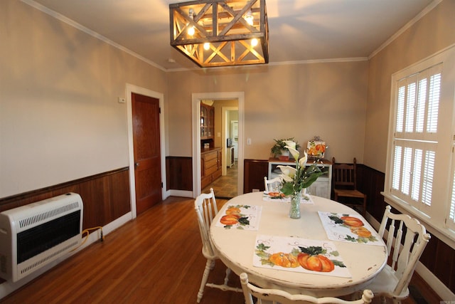 605 School St, Sheridan, AR 72150 - dining room featuring healthy amount of natural light, wainscoting, heating unit, dark wood-type flooring, and ornamental molding