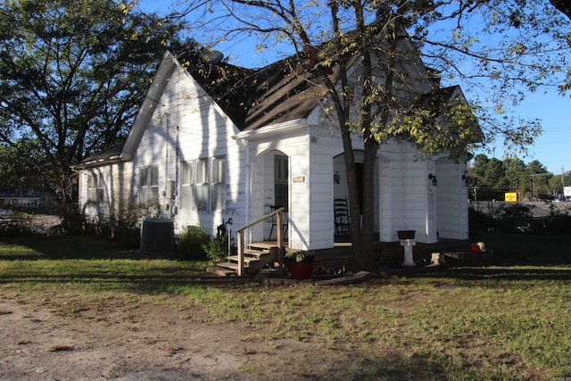 605 School St, Sheridan, AR 72150 - view of side of property with central air condition unit, a yard, and entry steps