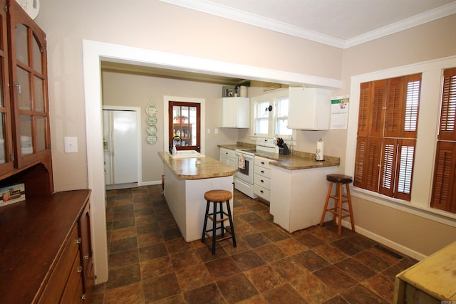605 School St, Sheridan, AR 72150 - kitchen with white electric range oven, a sink, a kitchen bar, ornamental molding, and white cabinets