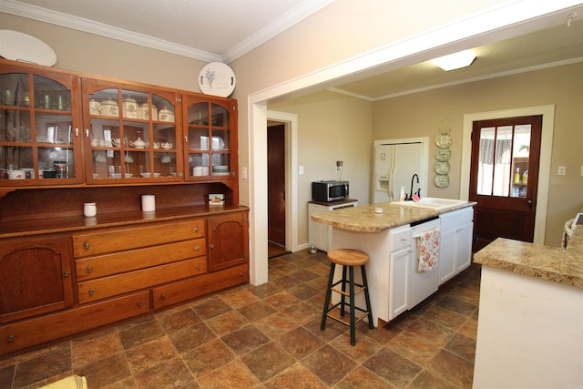 605 School St, Sheridan, AR 72150 - kitchen featuring dishwasher, a sink, stainless steel microwave, stone finish flooring, and crown molding