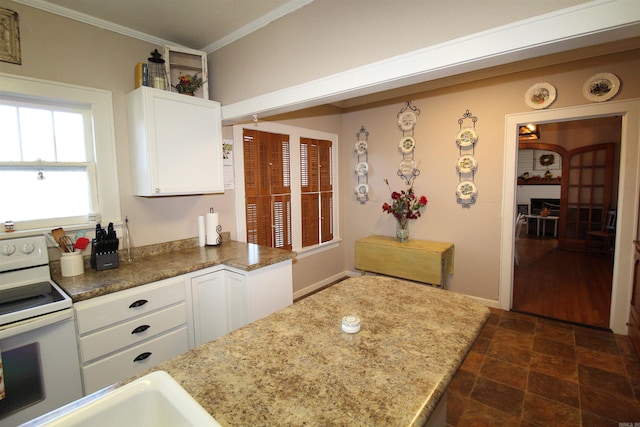 605 School St, Sheridan, AR 72150 - kitchen with electric range, crown molding, white cabinets, dark stone finish floors, and a sink
