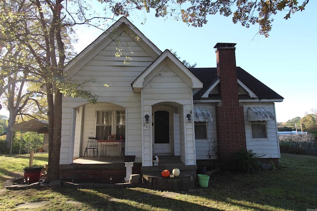 605 School St, Sheridan, AR 72150 - view of front of property featuring a porch, a chimney, and a front yard