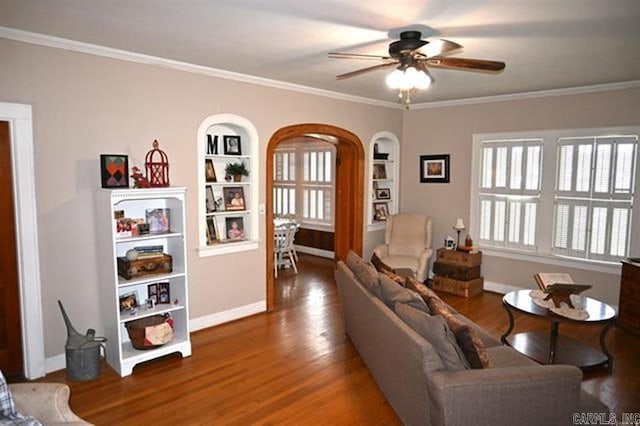 605 School St, Sheridan, AR 72150 - living area with arched walkways, ceiling fan, built in features, ornamental molding, and wood finished floors
