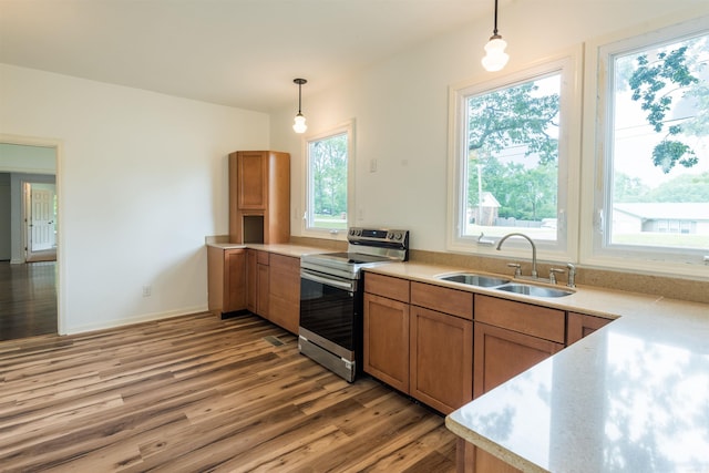 919 River Rdg, Benton, AR 72019 - kitchen featuring stainless steel range with electric cooktop, a sink, light wood finished floors, and pendant lighting