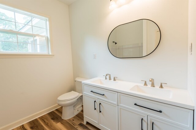 919 River Rdg, Benton, AR 72019 - bathroom with wood finished floors, double vanity, toilet, and baseboards