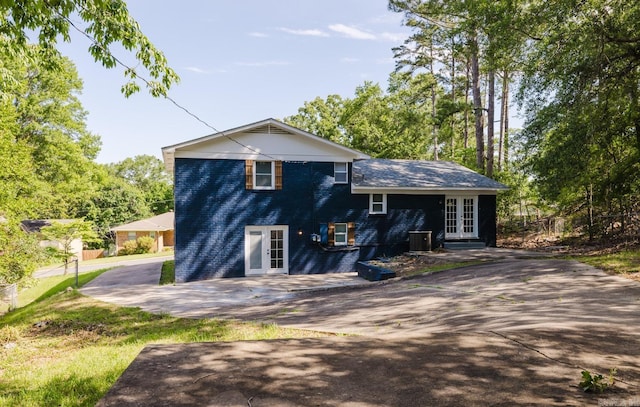 41 Brookridge Dr, Little Rock, AR 72205 - view of front facade with french doors, central air condition unit, and driveway