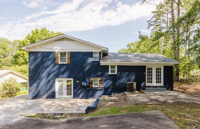 41 Brookridge Dr, Little Rock, AR 72205 - back of house featuring french doors, a patio area, central AC, and brick siding