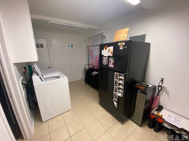 8 Westbrook Cv, Little Rock, AR 72205 - laundry room with washing machine and clothes dryer, cabinet space, and light tile patterned floors