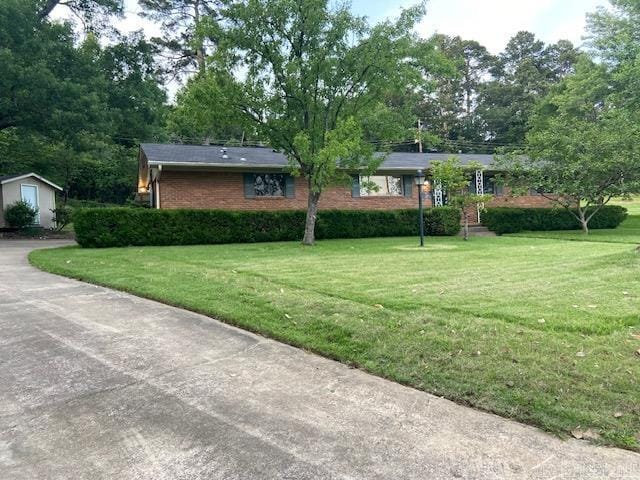 8 Westbrook Cv, Little Rock, AR 72205 - view of front of home featuring a front lawn, brick siding, and an outbuilding