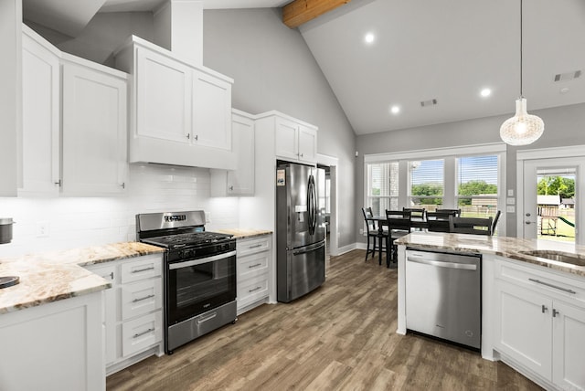 170 Irene Cir, Greenbrier, AR 72058 - kitchen with appliances with stainless steel finishes, beam ceiling, backsplash, white cabinets, and high vaulted ceiling