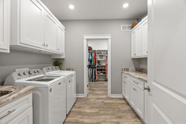 170 Irene Cir, Greenbrier, AR 72058 - laundry area featuring separate washer and dryer, cabinet space, light wood-type flooring, recessed lighting, and baseboards