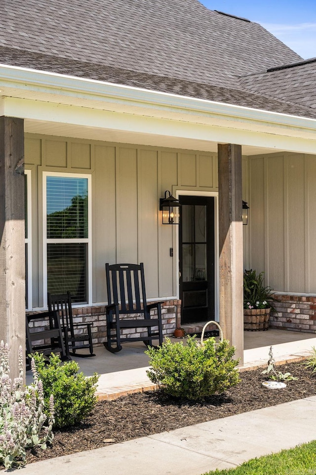 170 Irene Cir, Greenbrier, AR 72058 - view of exterior entry with a shingled roof, a porch, and board and batten siding