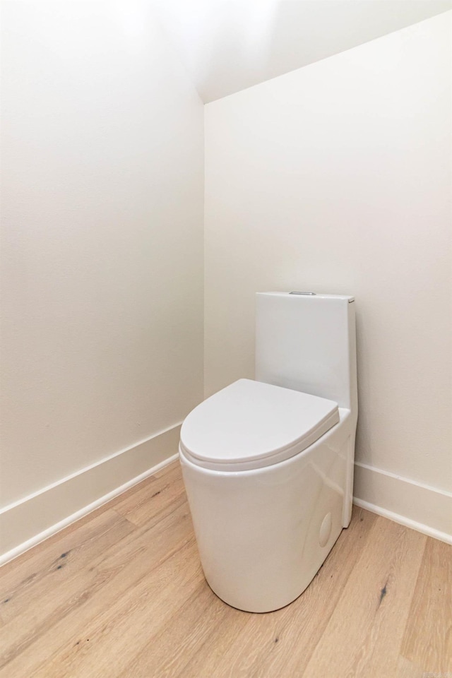 1615 N Garland Ave, Fayetteville, AR 72703 - bathroom with wood finished floors, baseboards, and toilet