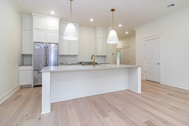 1615 N Garland Ave, Fayetteville, AR 72703 - kitchen featuring freestanding refrigerator, a sink, light wood-style floors, a large island with sink, and white cabinetry