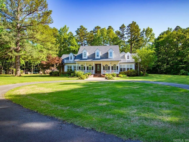 1 Witness Tree Ln, Paron, AR 72122 - cape cod home featuring covered porch, a front lawn, and view of scattered trees