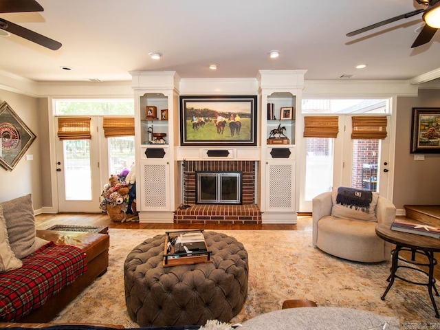 1 Witness Tree Ln, Paron, AR 72122 - living area with a ceiling fan, ornamental molding, a brick fireplace, and wood finished floors