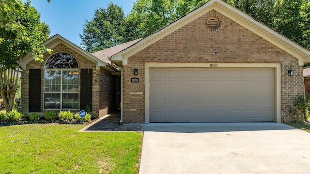 1050 Santa Fe Trl, Conway, AR 72034 - ranch-style home with brick siding, concrete driveway, a garage, and a front yard