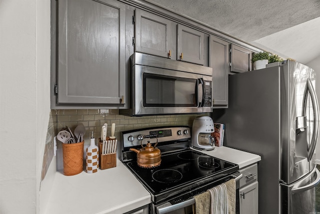1050 Santa Fe Trl, Conway, AR 72034 - kitchen with appliances with stainless steel finishes, light countertops, decorative backsplash, and a textured ceiling