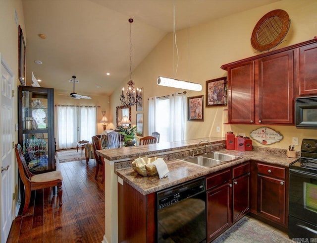 kitchen with black appliances, a sink, a peninsula, wood-type flooring, and dark brown cabinets