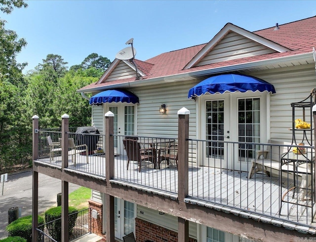 wooden deck featuring french doors, a patio, and outdoor dining space
