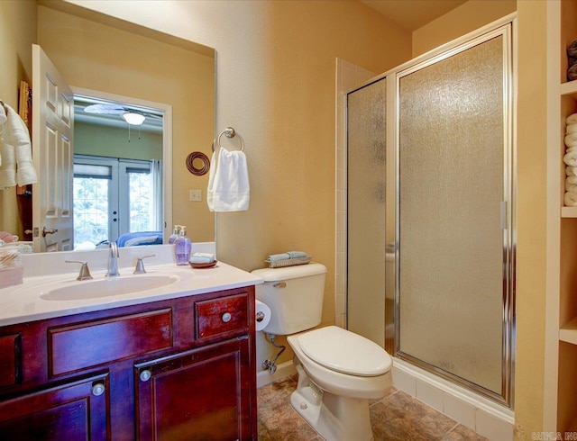 full bath with a shower stall, vanity, toilet, and french doors