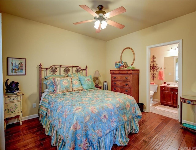 bedroom featuring wood-type flooring, ensuite bathroom, a ceiling fan, and baseboards