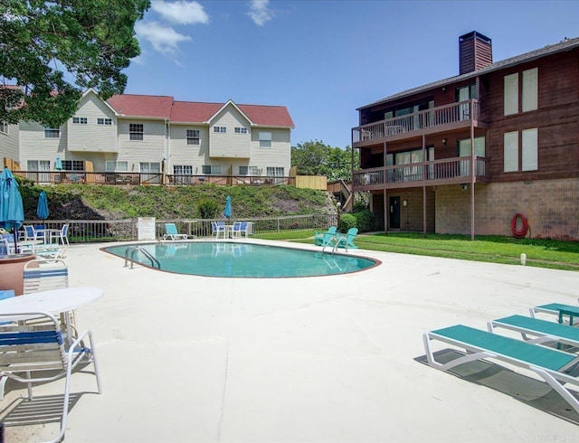 community pool with a patio area