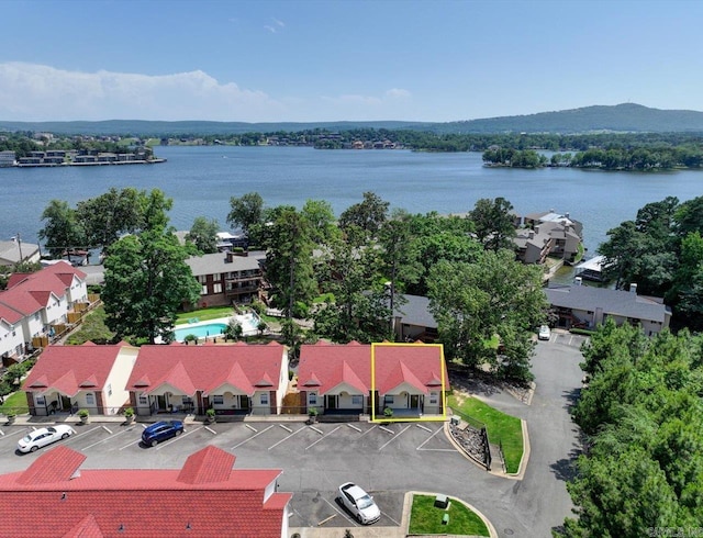 aerial view of property's location featuring property parcel outlined, a nearby body of water, and a pool area