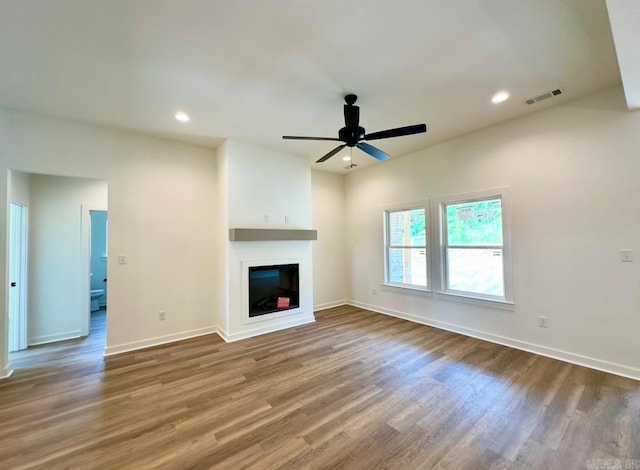 81 Lewis Loop, Greenbrier, AR 72058 - unfurnished living room featuring wood finished floors, ceiling fan, a glass covered fireplace, baseboards, and recessed lighting