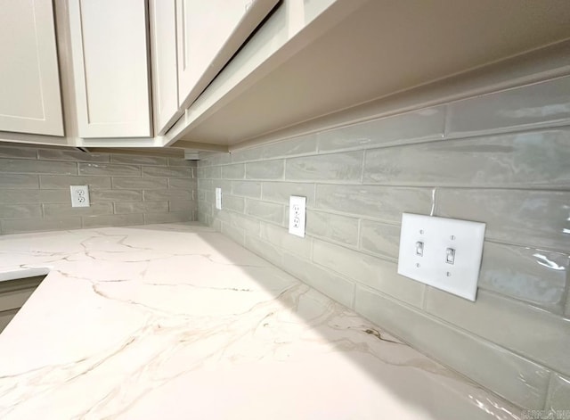 81 Lewis Loop, Greenbrier, AR 72058 - kitchen view of decorative backsplash, light stone counters, and white cabinetry