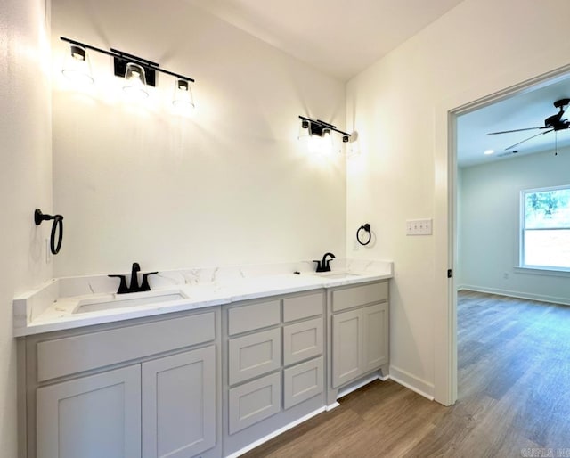 81 Lewis Loop, Greenbrier, AR 72058 - full bathroom featuring wood finished floors, double vanity, and baseboards