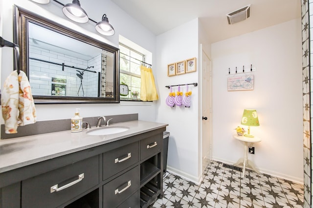 100 Hidgen Rdg, Higden, AR 72067 - bathroom featuring tile patterned floors, vanity, baseboards, and a shower