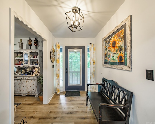 100 Hidgen Rdg, Higden, AR 72067 - entrance foyer featuring wood finished floors, a chandelier, and baseboards